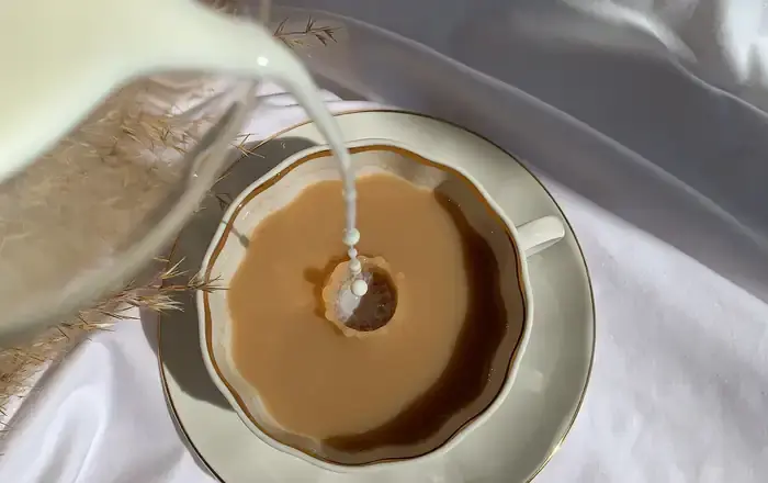 Milk poured into tea